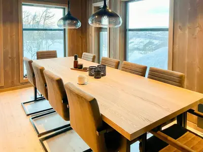 a conference room with a wooden table and chairs at Mountain Cabin At Hardangervidda in Uvdal