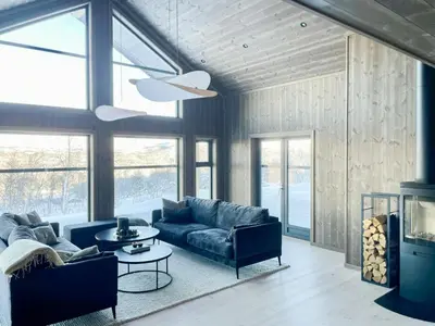 a living room with a couch and a table at Mountain Cabin At Hardangervidda in Uvdal