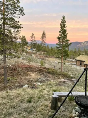 a view of a field with a bench and trees at Modern Cabin At The Gateway To Jotunheimen in Randsverk