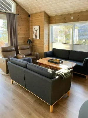 a living room with couches and a coffee table at Modern Cabin At The Gateway To Jotunheimen in Randsverk