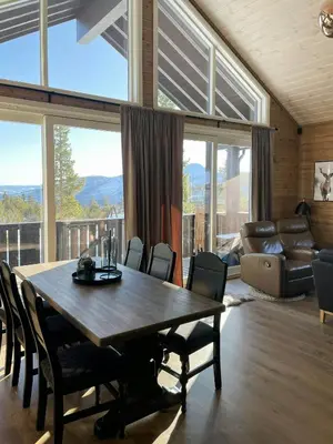a dining room with a large wooden table and chairs at Modern Cabin At The Gateway To Jotunheimen in Randsverk