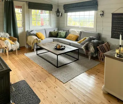 a living room with a couch and a coffee table at Family Cabin With Sun And Views At Ljøsheim in Mesnali
