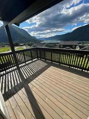 a wooden deck with a view of the mountains at Lom in Lom