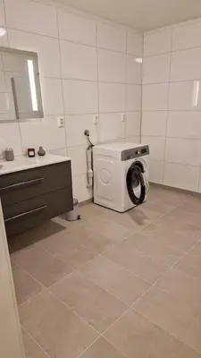 a washing machine in a bathroom with a sink at Lom in Lom