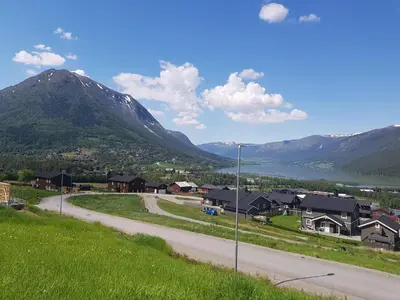 a road leading to a village with a mountain at Lom in Lom