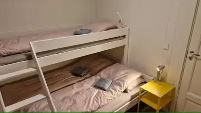 a bunk bed with two hats on top of it at Lom in Lom