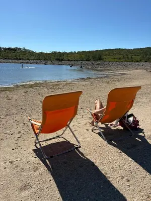 two chairs on a beach with a baby sitting in them at Møsstrond Turisthytte in Hovden