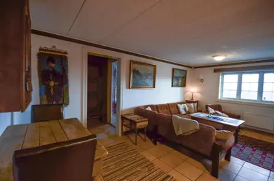 a living room with a couch and a table at Large Cabin With Stunning Views! in Beitostøl