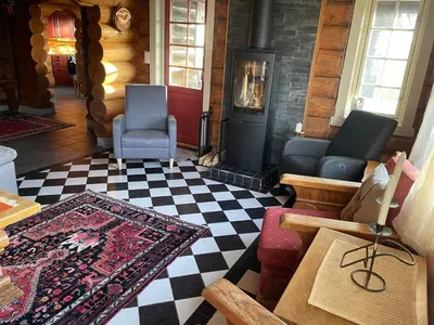 a living room with a fireplace and a rug at Large Cabin With Stunning Views! in Beitostøl