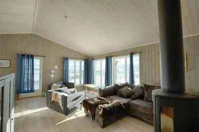 a living room with a couch and a stove at Modern Cabin At The Foot Of Bitihorn in Beitostøl