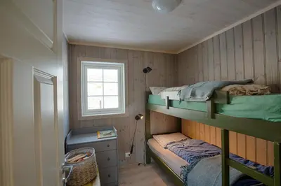 a small room with two bunk beds and a window at Modern Cabin At The Foot Of Bitihorn in Beitostøl