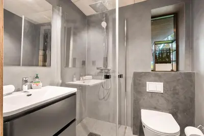 a bathroom with a shower and a sink and a toilet at Comfy studio apartment 200m from bryggen in Bergen