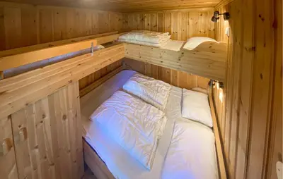 a room with two beds in a wooden cabin at Beautiful Home In Rjukan With Wifi in Rjukan