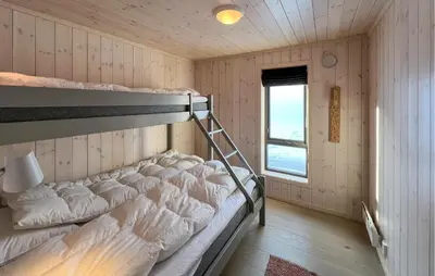 a bedroom with bunk beds in a room with a window at Gorgeous Home In Kvam With Sauna in Kvam