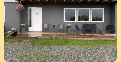 a patio with chairs and a table in front of a house at Leilighet i Sør-Fron kommune in Sør-Fron