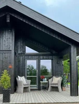 a wooden patio with two chairs and a table at Family Cabin With Jotunheim Mountain Views in Venabygd