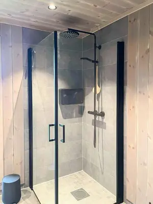 a shower with a glass door in a bathroom at Family Cabin With Jotunheim Mountain Views in Venabygd