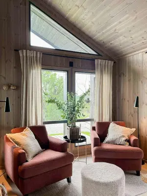 a living room with two chairs and a window at Family Cabin With Jotunheim Mountain Views in Venabygd