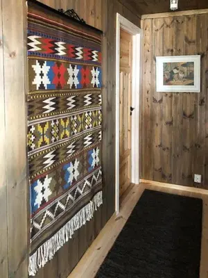 a hallway of a room with a wall covered in threads at Mountain Cabin With Views At Skeikampen in Svingvoll