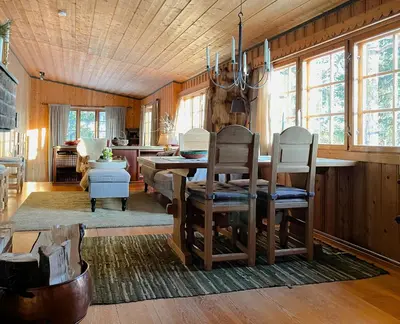 a dining room with a table and chairs at Modernized Cabin At Norefjell With View in Eggedal