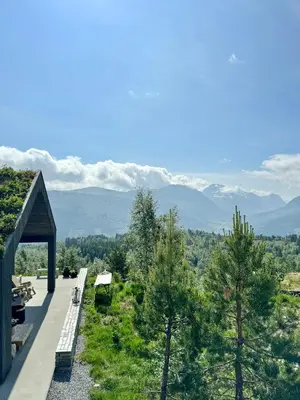 a house with a view of the mountains at Architect Cabin With Strandafjellet View in Stranda