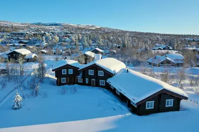 an aerial view of a house covered in snow at Charming Timber Lodge For Gathering And Celebrations in Beitostøl