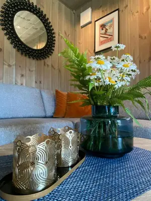 a living room with a table with a vase of flowers at Modern Apartment With Views Of Trysil Mountain in Trysil