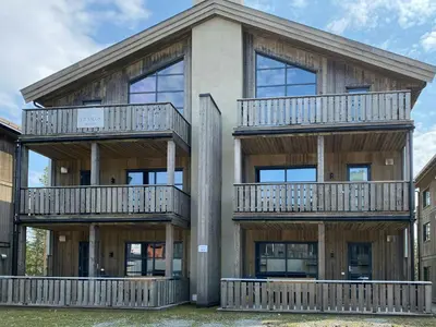 a house with balconies on the side of it at Modern Apartment With Views Of Trysil Mountain in Trysil
