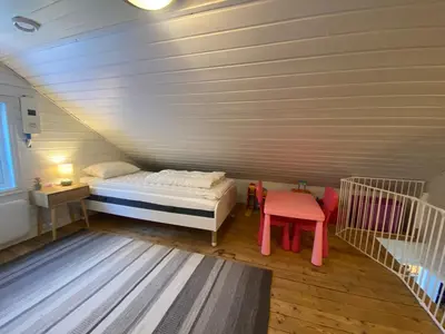 a small bedroom with a bed and a table at Child-friendly holiday home in Ålesund