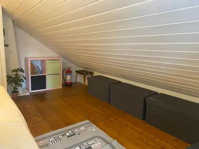 a living room with a couch and a wooden floor at Child-friendly holiday home in Ålesund