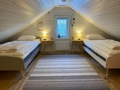 two beds in a room with a attic at Child-friendly holiday home in Ålesund