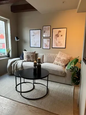 a living room with a couch and a table at Central apartment in idyllic Bakklandet in Trondheim