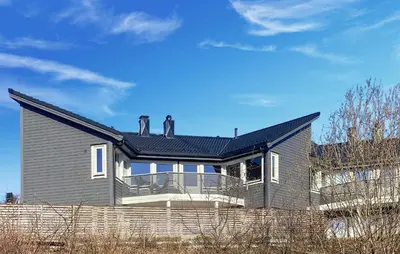 two people standing on the roof of a house at Lovely Home In Flaktveit With Wifi in Blinde