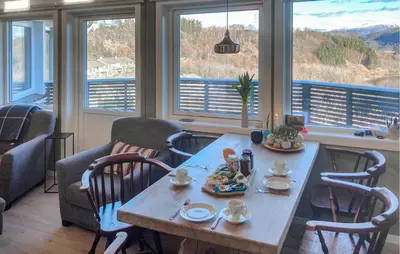 a table with food on it in a room with windows at Lovely Home In Flaktveit With Wifi in Blinde