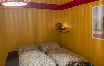 a living room with a couch in a yellow wall at Lovely Home In Flaktveit With Wifi in Blinde