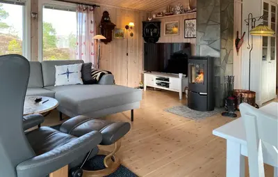 a living room with a couch and a fireplace at 2 Bedroom Amazing Home In Agdenes in Fremstad