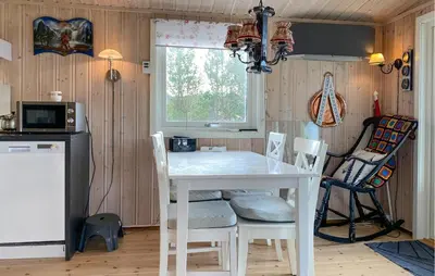 a kitchen with a white table and chairs at 2 Bedroom Amazing Home In Agdenes in Fremstad