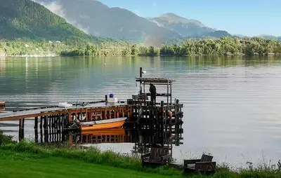 a boat is docked at a dock on a lake at 3 Bedroom Lovely Home In Valen in Valen