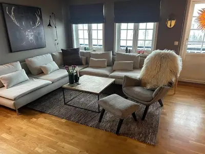 a living room with a couch and a table and chairs at Leilighet i 1 etg Røldal in Håra
