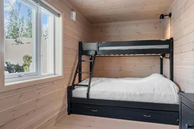 a bunk bed in a room with a window at Modern Family Cabin at Norefjell - Views and Hiking in Eggedal