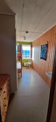 a room with a bedroom with a bed and a window at Haugen Gård in Oppdal