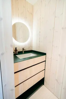 a bathroom with a sink and a mirror at The Crux Nordic Design Mountain Cabin in Åndalsnes