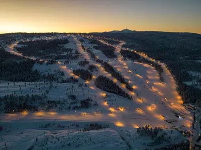 an aerial view of a road in the snow at night at The Holiday - Panorama Lodge in Lampeland