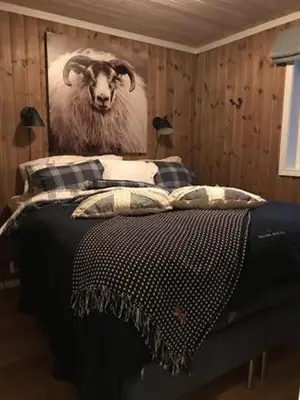 a bedroom with a bed with a picture of a sheep at Trysilmountainlodge in Hovi