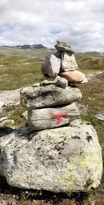a pile of rocks with a red arrow on top at Siribu in Vågsli