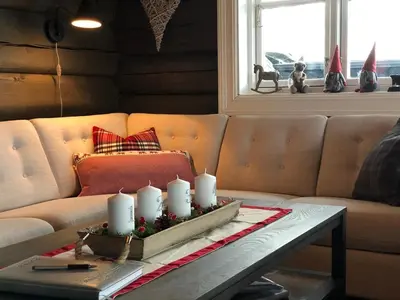 a living room with a couch with candles on a table at Siribu in Vågsli