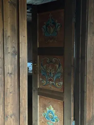 a wooden door with a design on it at Sjarmerende hytte på Geilo med 5 soverom in Geilo