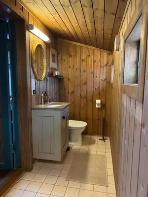 a wooden bathroom with a toilet and a sink at Sjarmerende hytte på Geilo med 5 soverom in Geilo