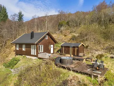 a log cabin with a hot tub in front of it at Peaceful Cabin With Spa On Osterøy in Bruvik