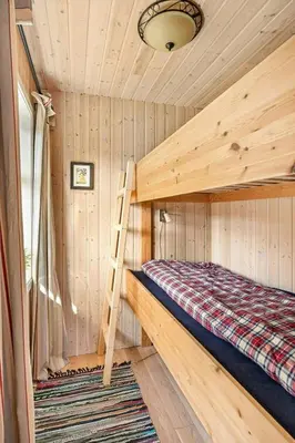 a bedroom with a bunk bed in a cabin at Peaceful Cabin With Spa On Osterøy in Bruvik